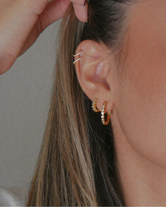 baguette cubic zirconia stone scattered 18k gold plated sterling silver huggie hoop earrings worn in the second piercing