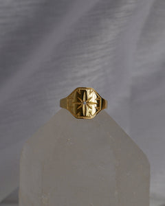 statement signet gold ring with engraved north star and cubic zirconia stone detail