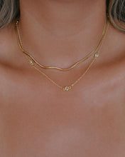 Load image into Gallery viewer, dainty gold necklace with satellite cubic zirconia bezel set stones styled with a thin gold herringbone chain
