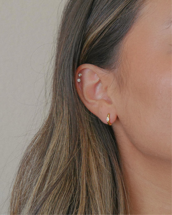 gold huggie hoop earrings with bezel set marquise cubic zirconia stone