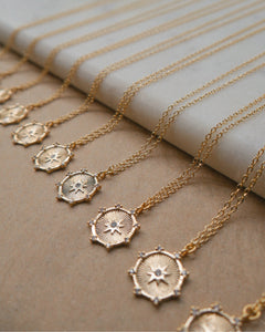 dainty gold chain necklace with north star coin pendant